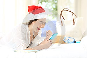 Excited woman using a phone on christmas holidays