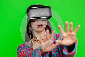 Excited woman using virtual reality futuristic technology headset to play simulation 3D video game