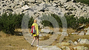 Excited woman walking through landscape outdoors. An active girl enjoys her