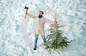 Excited woodsman with Christmas tree. Winter portrait of lumber in snow Garden cutting Christmas tree. Happy winter time