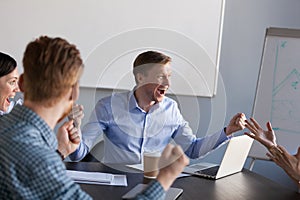 Excited workers scream for shared business goal achievement