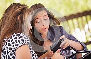 Excited Young Adult Girlfriends Using Their Smart Phone