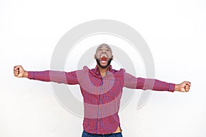 Excited young african man with arms outstretched shouting