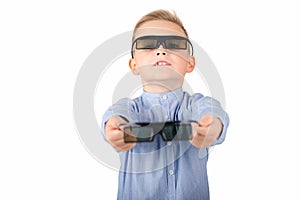 Excited young american schoolboy in 3d imax glasses posing on white isolated background in studio