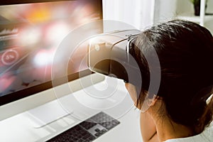 Excited young Asian woman using a virtual reality headset and joysticks, Concept connection and interfaces of digital technology.