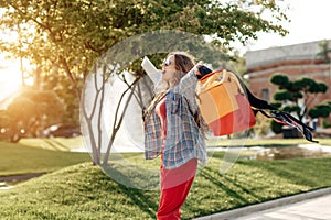 Excited young blonde woman student celebrate success after exams in university.