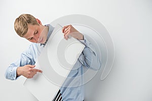 Excited young businessman holding a blank board