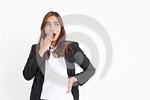 Excited young businesswoman surprised with hands in front of mouth and eyes glancing sideways with space