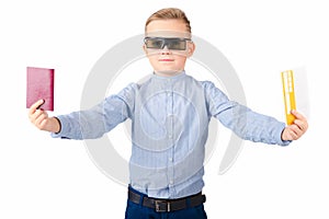 Excited young caucasian schoolboy in 3d imax glasses posing isolated on white background in studio.Holds passport ticket photo