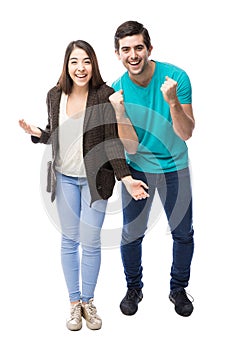 Excited young couple celebrating
