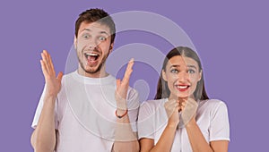 Excited young couple screaming happily at camera