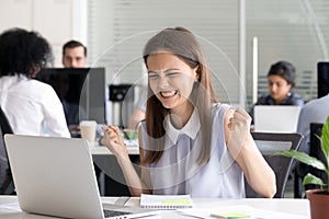 Excited young girl celebrating success achievement result