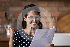 Excited young latin woman enjoy great business news from letter