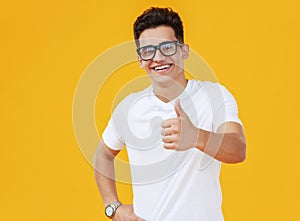 Excited young male shows thumb up
