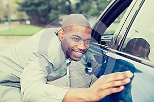 Excited young man and his new car