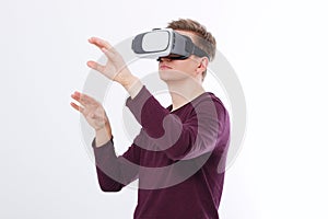 Excited young man in a VR headset, glasses. Virtual reality isolated on white background. Copy space and mock up