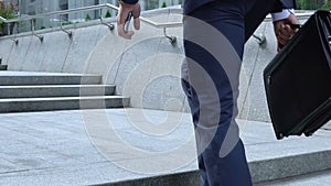 Excited young office worker looking high government building, work opportunities