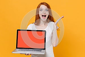 Excited young redhead woman girl in white t-shirt posing isolated on yellow background. People lifestyle concept. Mock