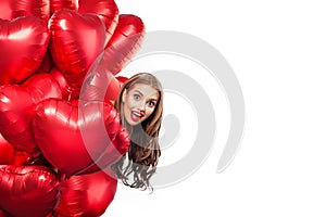 Excited young woman with balloons red heart isolated on white background. Surprised girl. Surprise, valentines people