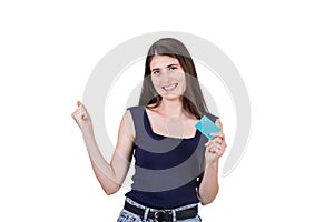 Excited young woman celebrating financial success while holding a credit card in hand, isolated on white background with copy