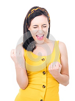 Excited young woman with clenched fists, isolated on white background. Yes concept. Good news. Rejoicing female celebrates success