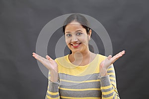 Excited young woman gesturing an open hands