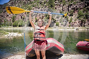 Excited Young woman going river rafting down the Green River while on her summer vacation in Utah