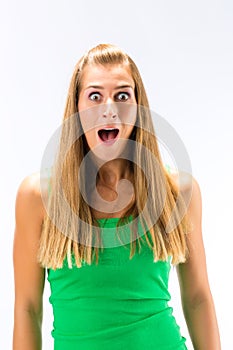 Excited young woman in green tanktop