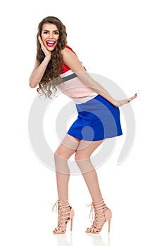 Excited Young Woman In Mini Dress And High Heels