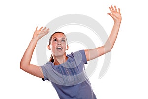 Excited young woman screaming with hands up