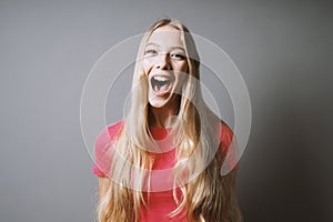 Excited young woman whoop of joy or shout of delight photo