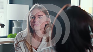 Excitement concept. Portrait of beautiful smiling young 20-25 year old Caucasian blonde woman talk to colleague at work.