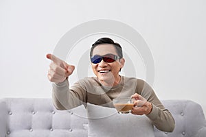 Exciting asian men watch three-dimensional LCD TV with eye glass