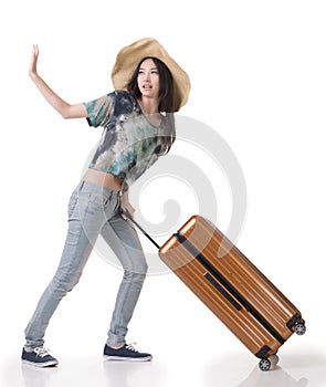 Exciting Asian woman drag a luggage