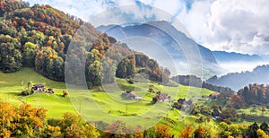 Exciting autumn view on suburb of Stansstad city with mountaines and fog