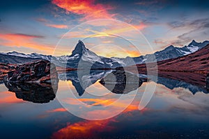 Exciting morning view of Stellisee lake with Matterhorn / Cervino peak on background.