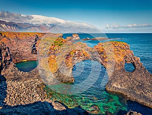 Exciting summer view of popular tourist destination - Gatklettur, Arnarstapi or Stapi village location. photo