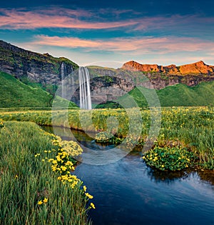 Exciting sunset on popular tourist destination - Seljalandsfoss waterfall