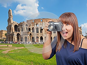 Exciting woman taking photo Colosseum Rome