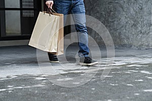 Exciting young shopping man hold bags