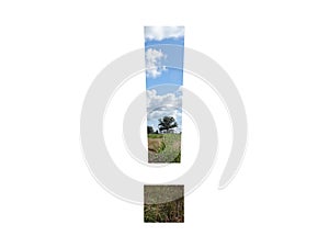 exclamation mark of the alphabet made with landscape with cloud, blue sky, trees, sun, grass and moorland