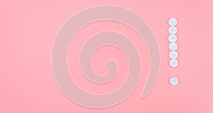 Exclamation mark from medical pills on a pink background. Treatment theme concept. Banner. Copy space