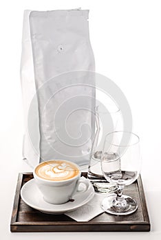 Exclusive art coffee set with glass of water and sack of coffee bean, hot drink product photography, cappuccino