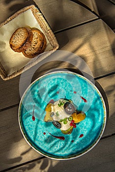 Exclusive cheese mousse with marinated walnuts and golden beetroot served on turquoise plate, top gastronomy