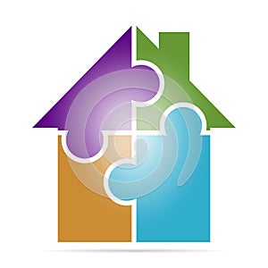 Exclusive Corporate business colorful sign with a house made of four puzzles of different colors . Icon of family house on a white