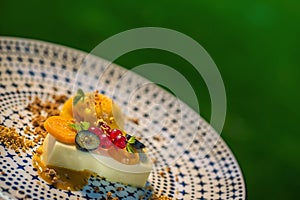 Exclusive italien panna cotta with mango sorbet and fruit served on plate, modern gastronomy, summer dessert