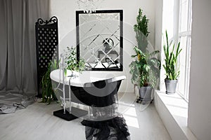 Exclusive modern black and white bathroom interior in luxury mansion with big window