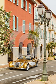 Exclusive vintage car is standing on narrow small streets, replica on the famous convertible car in French Riviera, Cap