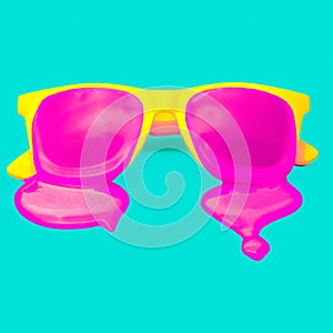 Exclusive yellow hipster sunglasses on blue background.