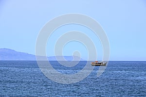 Excursion boat cruising Venetian harbour and mediterranean sea of Chania, Crete, Greece